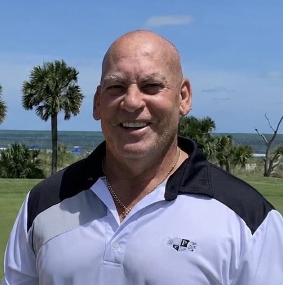 Charles “Rocky” Cotugno Jr. smiling outdoors in a golf shirt